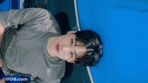 Man In Grey Shirt With Silver Chain GIF