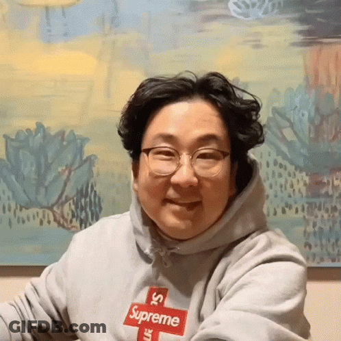 Man In Grey Supreme Hoodie With Red Logo GIF