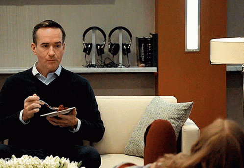 Man In Grey Sweater And Black Pants Sitting GIF