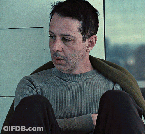 Man In Grey Sweater And Black Pants Sitting GIF