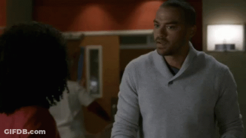Man In Grey Sweater Looking At Another Man GIF