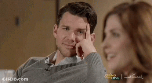 Man In Grey Sweater Next To Woman In Hallmark Spring Of Love Ad GIF