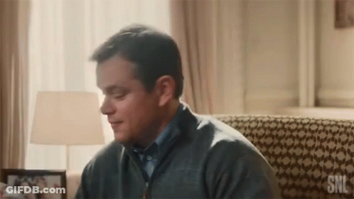 Man In Grey Sweater Sitting On Couch With SNL GIF