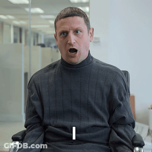 Man In Grey Sweater With Letter I On Shirt GIF