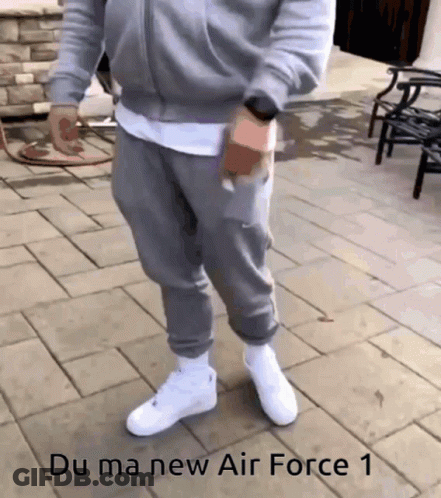 Man In Grey Sweatpants Standing On Brick Sidewalk Saying Du Ma New Air GIF