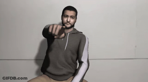 Man In Grey Sweatshirt Pointing At Camera GIF