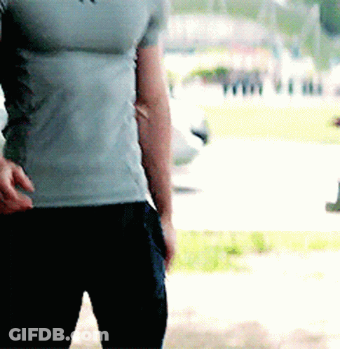 Man In Grey T-Shirt And Black Pants Standing In Park GIF