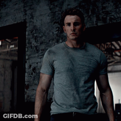 Man In Grey T-Shirt In Front Of Brick Wall GIF
