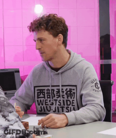 Man In Grey Westside Jiu-Jitsu Sweatshirt At Table GIF