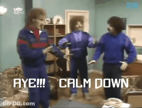 Man In Group Saying Calm Down GIF