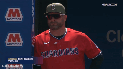Man In Guardians Jersey In Front Of Marathon Sign GIF
