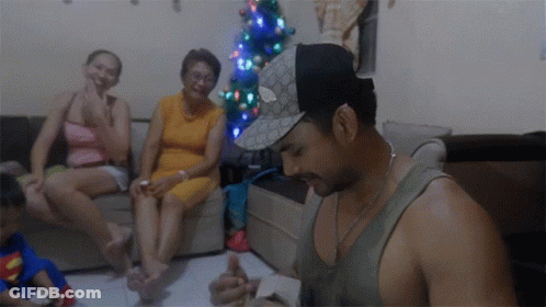 Man In Gucci Hat Sitting In Living Room GIF