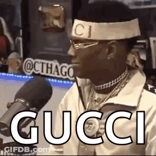 Man In Gucci Headband At Microphone GIF
