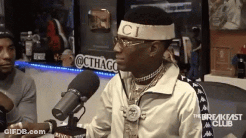 Man In Gucci Headband Sitting At Microphone GIF