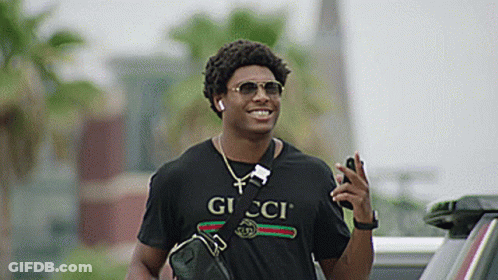 Man In Gucci T-Shirt And Sunglasses Talking On Cell Phone GIF