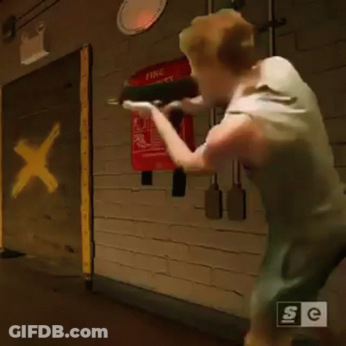 Man In Hallway With Fire Blanket GIF
