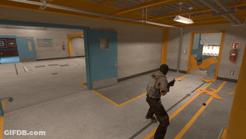 Man In Hallway With Fire Extinguisher Sign B GIF