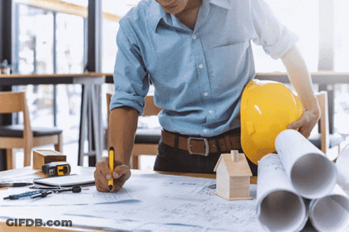 Man In Hard Hat And Blue Shirt Writing On Paper GIF