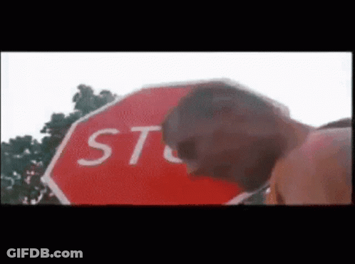 Man In Hard Hat And Glasses Next To Stop Sign Saying Stop Having Sex GIF