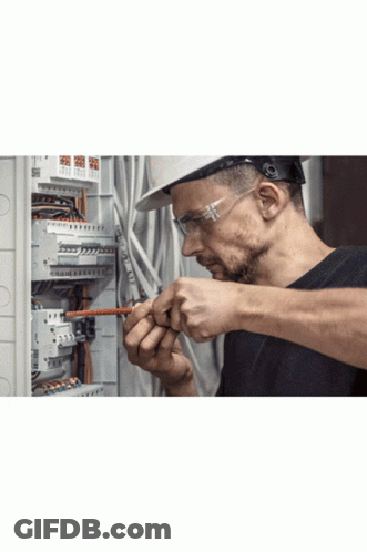 Man In Hard Hat And Safety Glasses Working On Circuit Board GIF