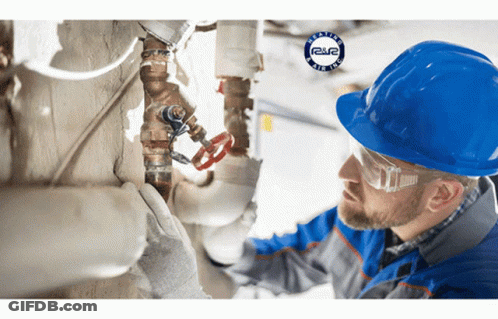 Man In Hard Hat And Safety Glasses Working On Pipe GIF