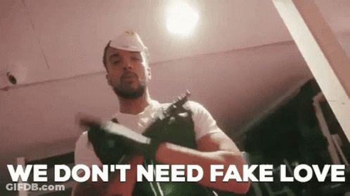 Man In Hard Hat Holding Gun Says We Don't Need Fake Love GIF