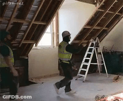 Man In Hard Hat Holding Ladder In Attic GIF