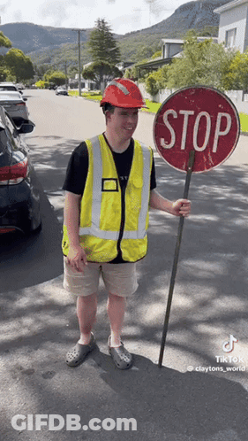 Man In Hard Hat Holding Stop Sign GIF