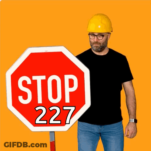 Man In Hard Hat Next To Stop Sign GIF