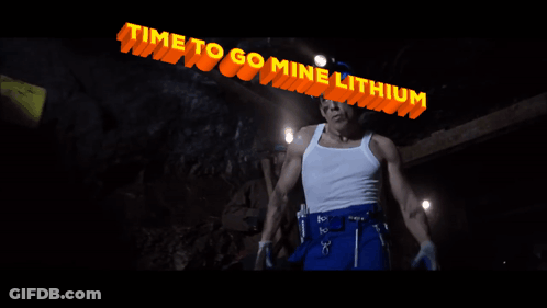 Man In Hard Hat Under Lithium Sign GIF