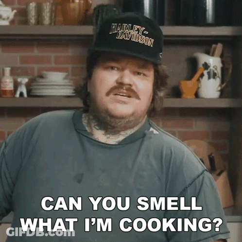 Man In Harley Davidson Hat Smell What He Is Cooking GIF