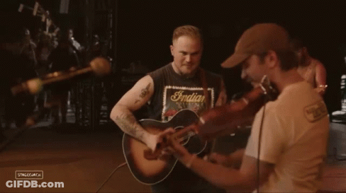 Man In Harrigan's T-Shirt Playing Violin GIF
