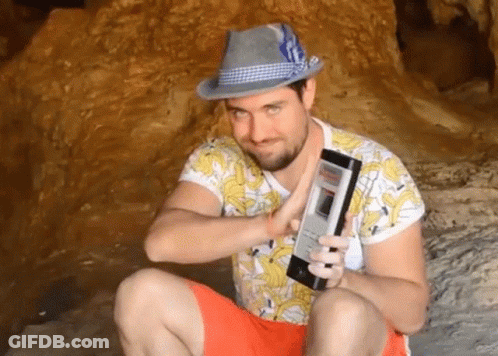 Man In Hat And Banana Shirt Holding Phone GIF