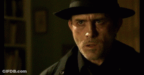 Man In Hat And Black Coat Making Funny Face GIF