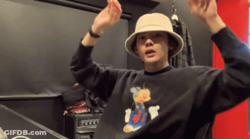Man In Hat And Black Mickey Mouse Shirt GIF