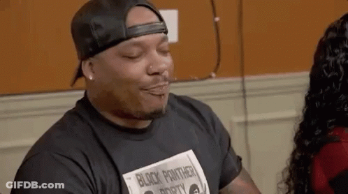 Man In Hat And Black Panther T-Shirt Beside Woman With Eyes Closed GIF