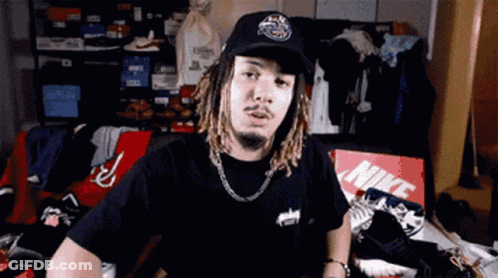 Man In Hat And Black Shirt Sitting By Nike Box GIF