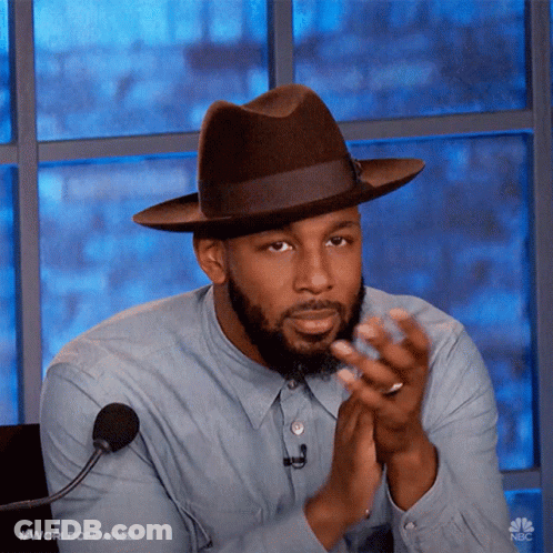 Man In Hat And Blue Shirt Clapping At Microphone GIF
