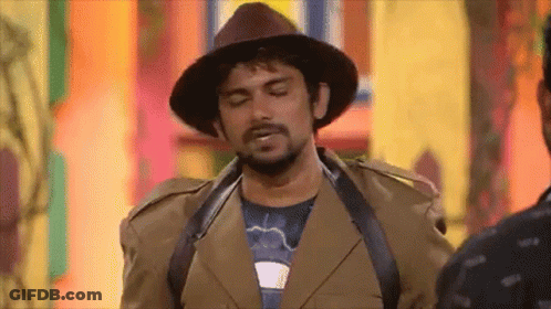 Man In Hat And Brown Jacket Standing Next To Another Man GIF