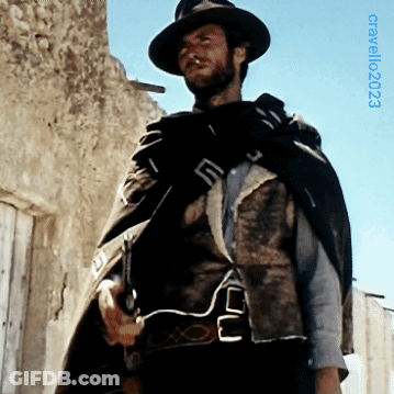 Man In Hat And Cape In Front Of Building With 2003 GIF