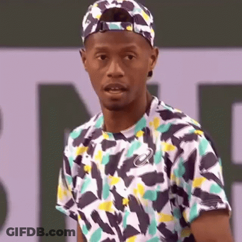 Man In Hat And Colorful Shirt On Tennis Court GIF