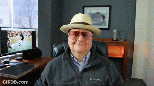 Man In Hat And Columbia Jacket Sitting At Computer GIF