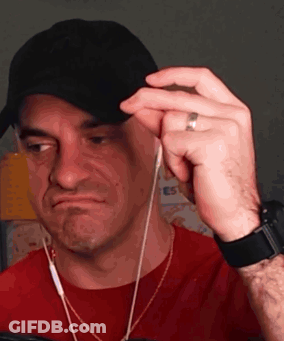 Man In Hat And Earbuds Making A Face GIF