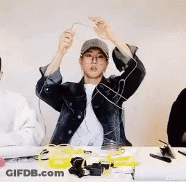 Man In Hat And Glasses At Table With Electronics GIF