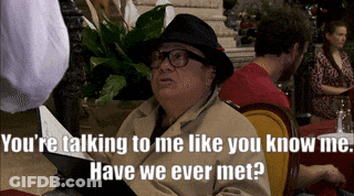 Man In Hat And Glasses Talking At Table GIF