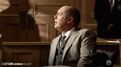 Man In Hat And Glasses Talks To Woman #Theblacklist GIF