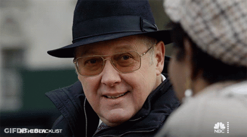 Man In Hat And Glasses Talks To Woman #Theblacklist GIF