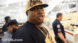 Man In Hat And Glasses With Police Officer In Grocery Store GIF