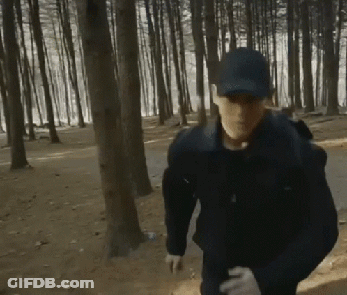 Man In Hat And Gloves Running Through Forest GIF