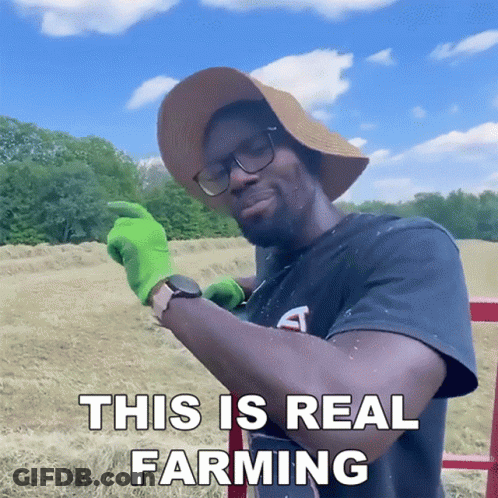 Man In Hat And Green Gloves Farming GIF